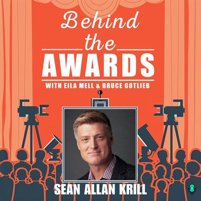 #23 - Sean Allan Krill - has one hand in his pocket and the other one is holding a Grammy